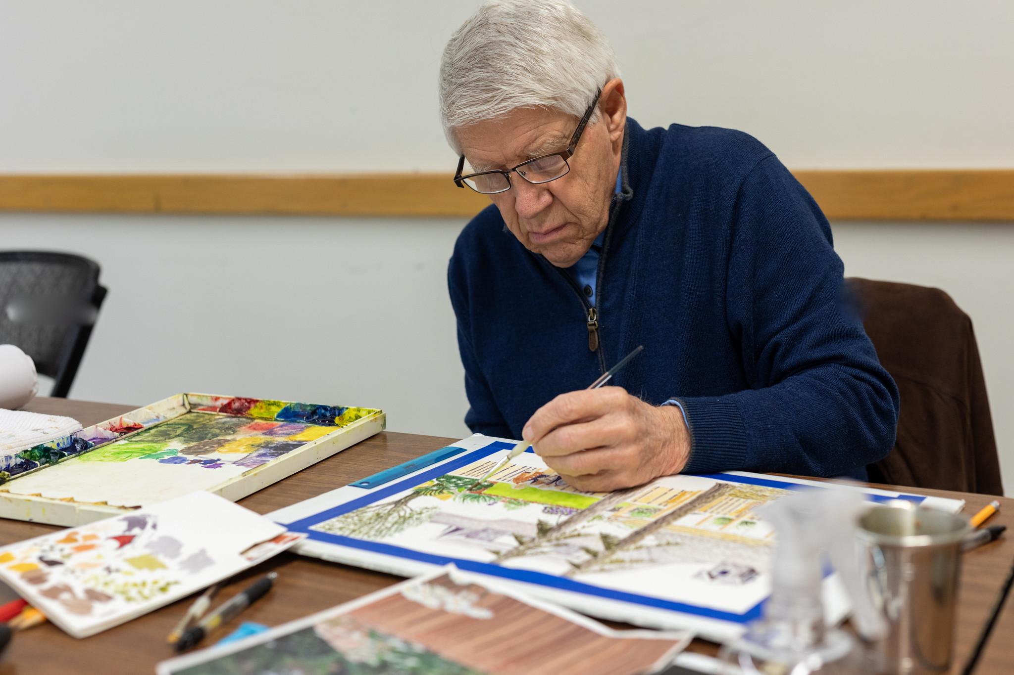 Photo of a student painting with watercolors